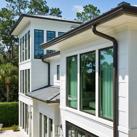 White Florida home with a dark gutter system along the roofline